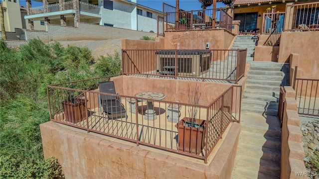 exterior space featuring stairs, outdoor dining space, and a patio area