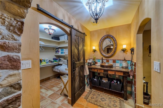 bathroom with stone tile flooring and vanity