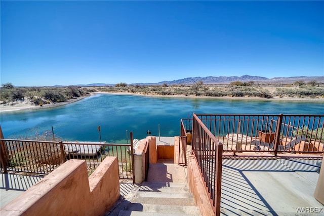 view of dock featuring a water and mountain view