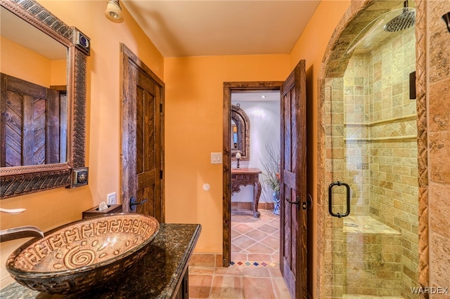 bathroom featuring a shower stall and vanity