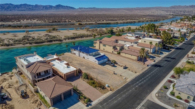 bird's eye view with a water and mountain view