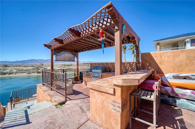 view of patio / terrace featuring a grill, outdoor dry bar, a pergola, and area for grilling