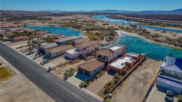 drone / aerial view with a water and mountain view