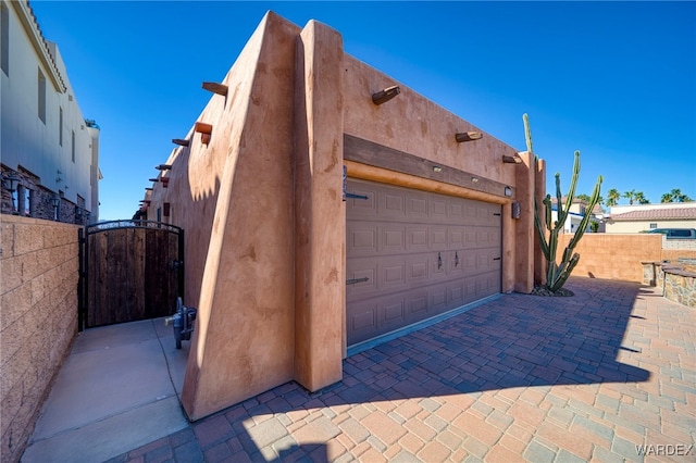 garage featuring a gate and fence