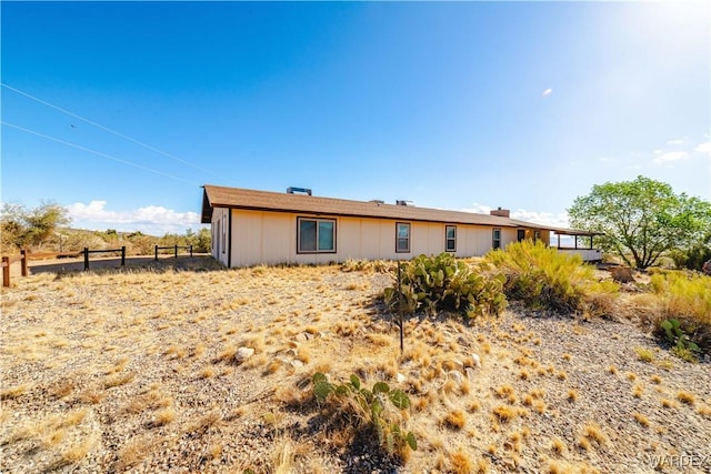 rear view of property with fence