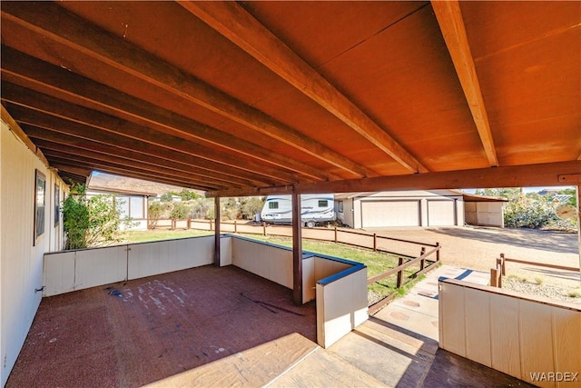 view of patio featuring an outbuilding