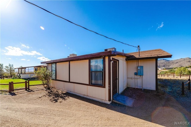 view of side of home with fence