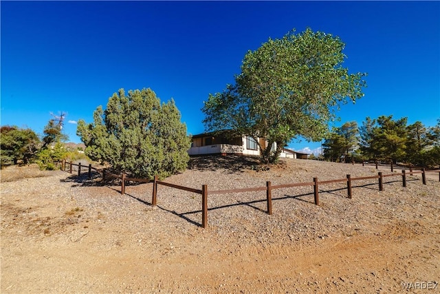 view of yard featuring a rural view and fence