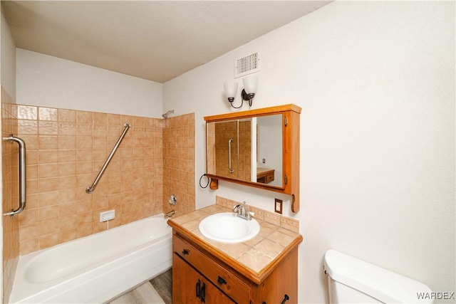 full bath with shower / bath combination, visible vents, toilet, and vanity