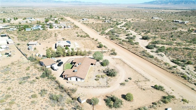 birds eye view of property featuring a mountain view, a rural view, and view of desert