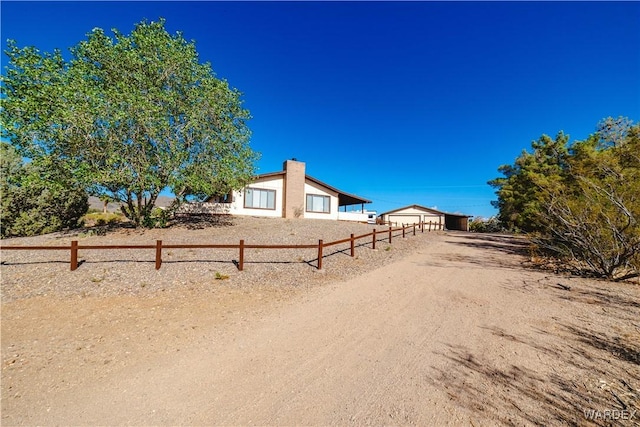 view of yard featuring fence and driveway