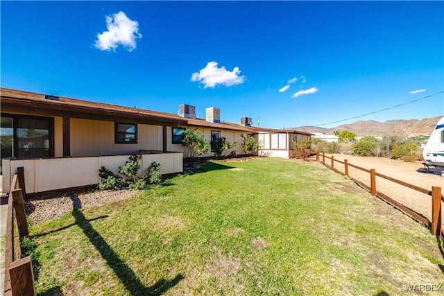 view of yard with a mountain view and fence