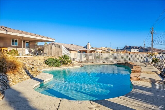 view of swimming pool featuring a fenced in pool, a patio, and a fenced backyard