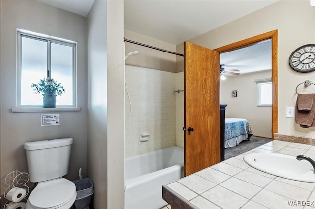 ensuite bathroom featuring toilet, shower / washtub combination, connected bathroom, ceiling fan, and vanity