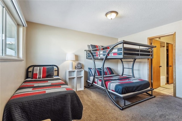 carpeted bedroom with a textured ceiling