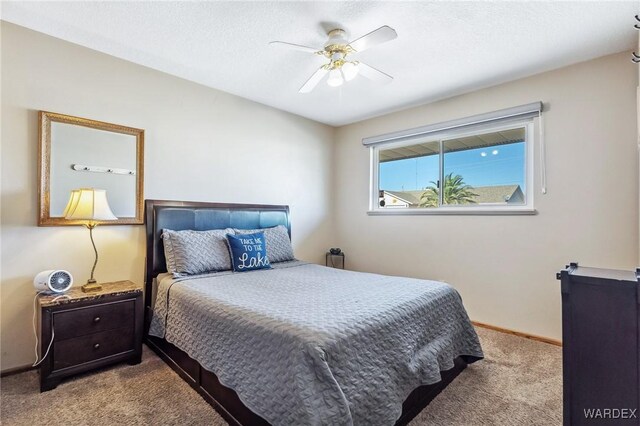 carpeted bedroom with baseboards, a textured ceiling, and ceiling fan