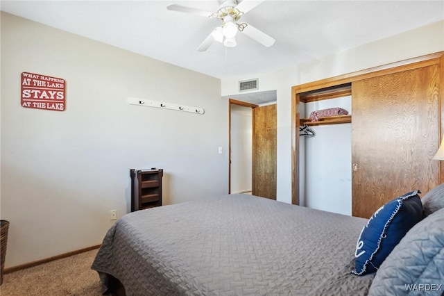 carpeted bedroom featuring visible vents, baseboards, a closet, and a ceiling fan