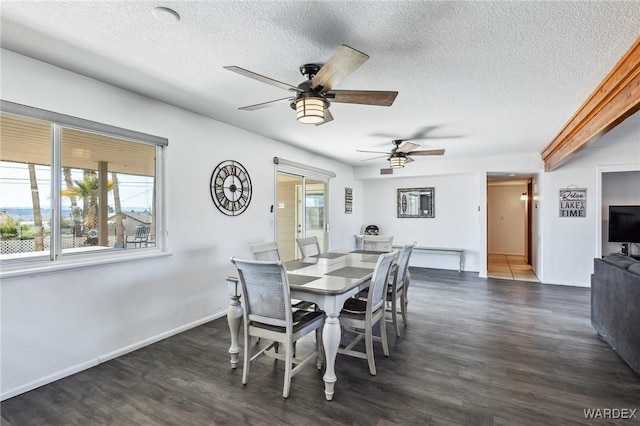 dining area with ceiling fan, baseboards, dark wood-style flooring, and a textured ceiling