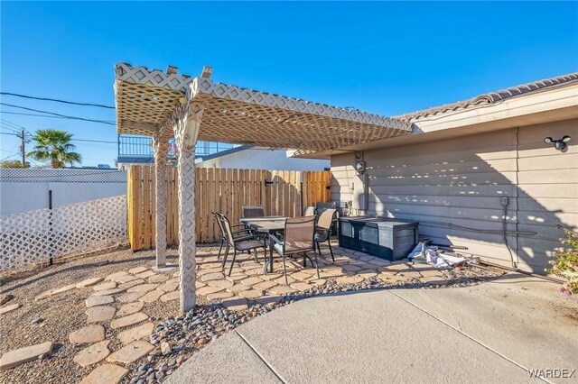 view of patio / terrace with outdoor dining space, fence, and a pergola