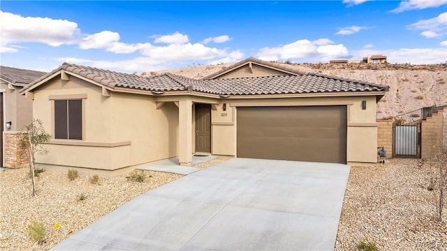 view of front facade featuring driveway, a tiled roof, an attached garage, and stucco siding