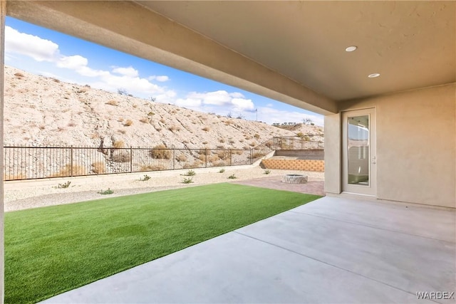 view of yard featuring a patio area, a fenced backyard, and a fire pit