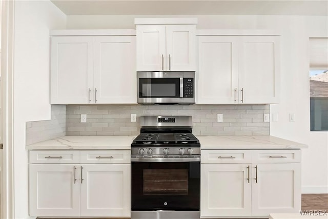 kitchen featuring stainless steel appliances and white cabinetry