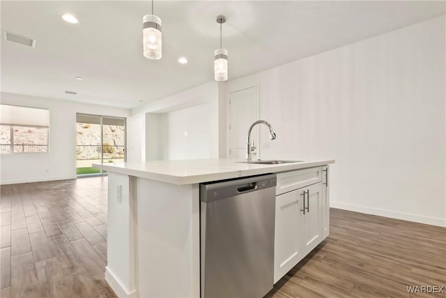 kitchen with dishwasher, open floor plan, decorative light fixtures, light countertops, and white cabinetry