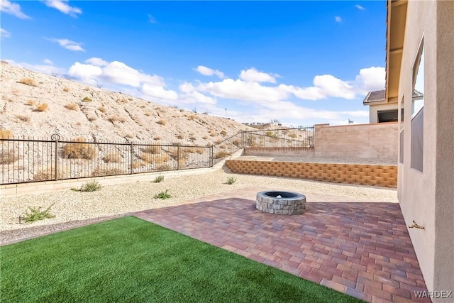 view of patio / terrace with an outdoor fire pit and a fenced backyard