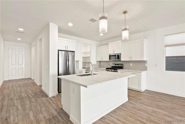 kitchen with stainless steel appliances, decorative light fixtures, and white cabinets