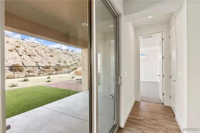 entryway featuring baseboards, visible vents, and light wood-style floors