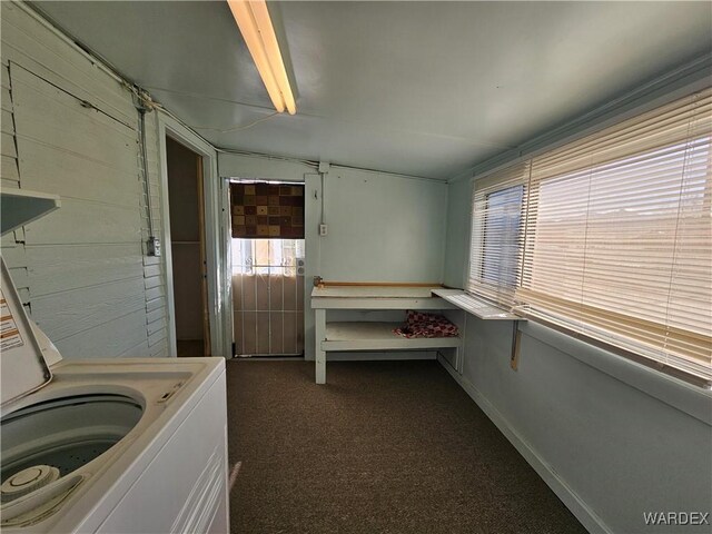 laundry room featuring washer / dryer, laundry area, dark carpet, and baseboards