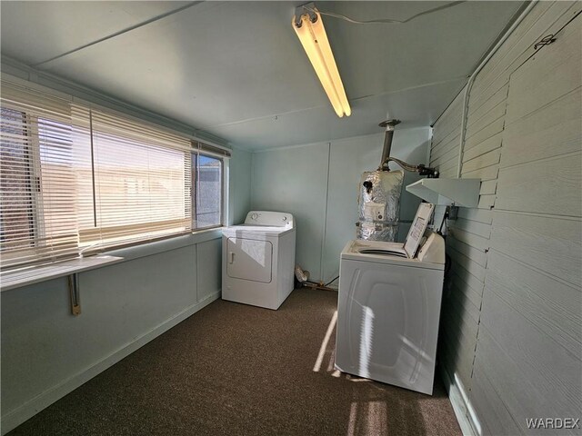 laundry room with water heater, laundry area, washer and clothes dryer, and dark colored carpet