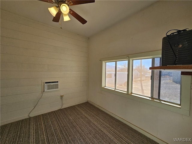 empty room featuring carpet, wooden walls, a ceiling fan, and an AC wall unit