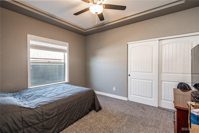 bedroom with ceiling fan, carpet floors, a closet, and baseboards