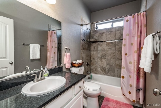 bathroom with shower / bath combo, a textured wall, vanity, and toilet