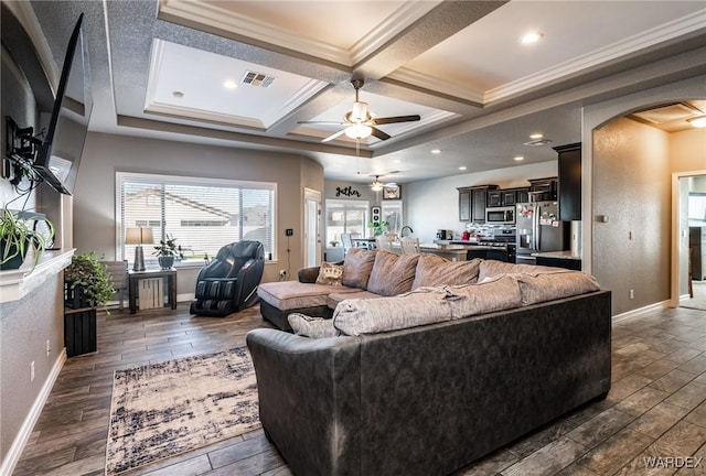 living area with coffered ceiling, arched walkways, visible vents, and wood finish floors