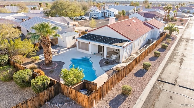 view of swimming pool featuring a fenced in pool, a patio area, central AC, a residential view, and a fenced backyard