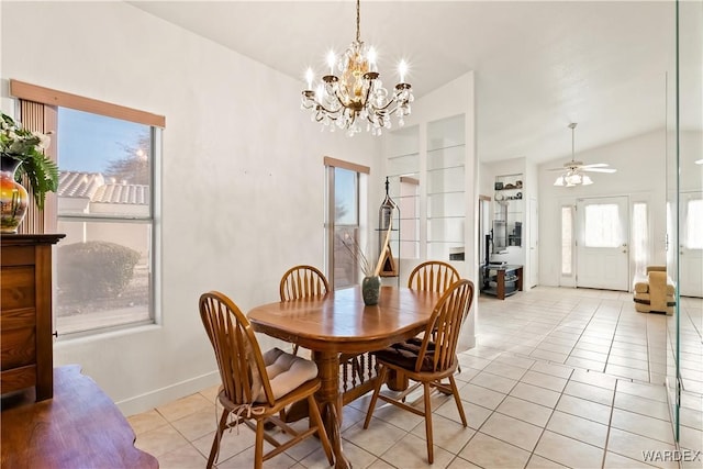 dining room with lofted ceiling, ceiling fan with notable chandelier, baseboards, and light tile patterned flooring