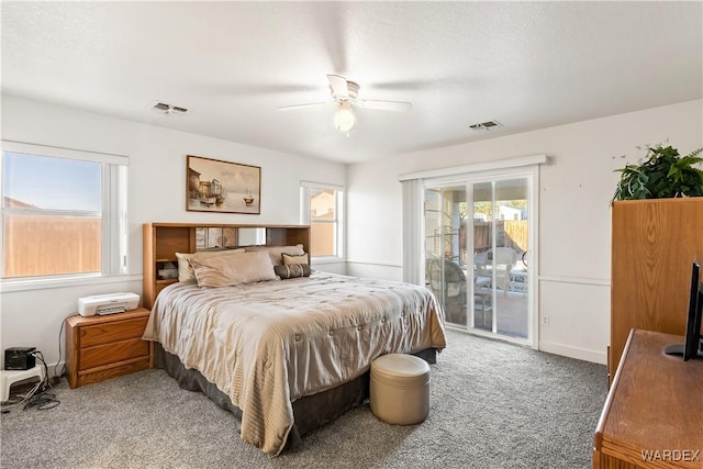 bedroom with access to exterior, visible vents, ceiling fan, and carpet flooring