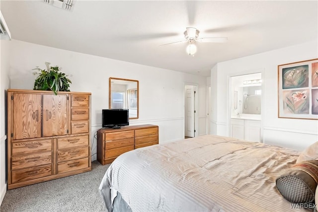 bedroom featuring ensuite bath, visible vents, ceiling fan, and light colored carpet