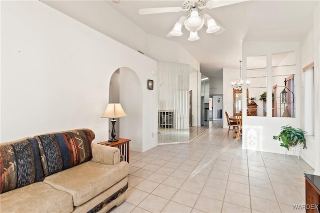 living area featuring ceiling fan with notable chandelier and light tile patterned floors