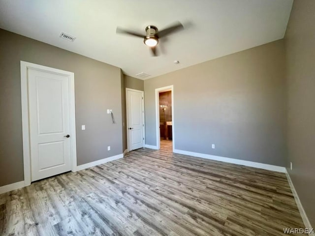 unfurnished bedroom featuring visible vents, ceiling fan, light wood-style flooring, and baseboards