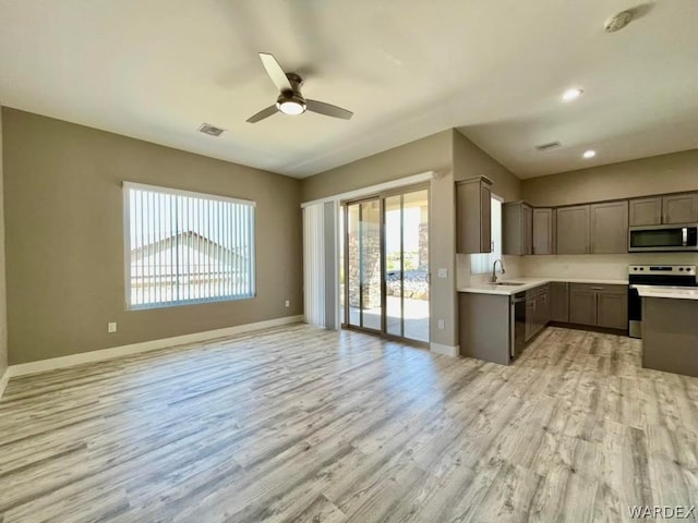 kitchen featuring light countertops, appliances with stainless steel finishes, a sink, and visible vents