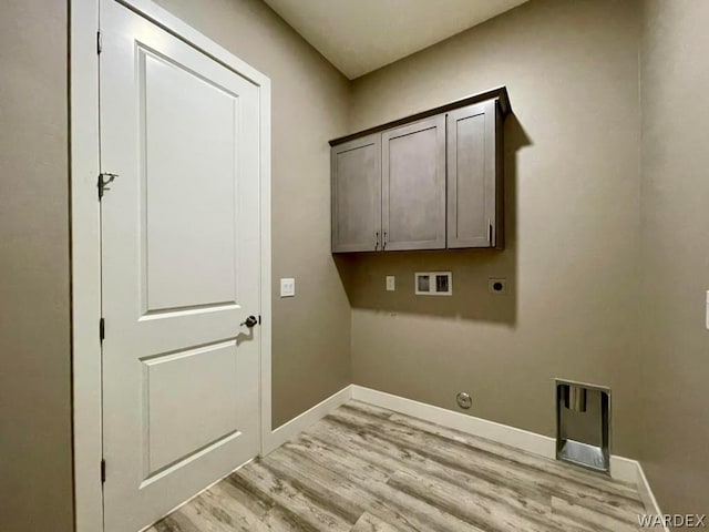 washroom with washer hookup, baseboards, light wood-type flooring, cabinet space, and electric dryer hookup