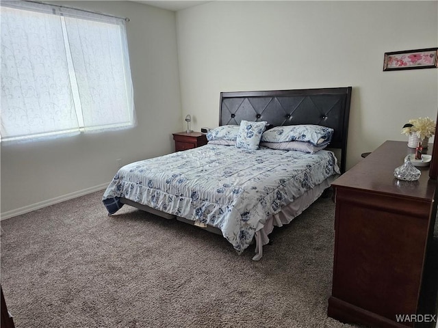 bedroom featuring baseboards and dark colored carpet