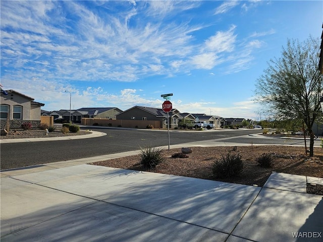 view of road with traffic signs and a residential view