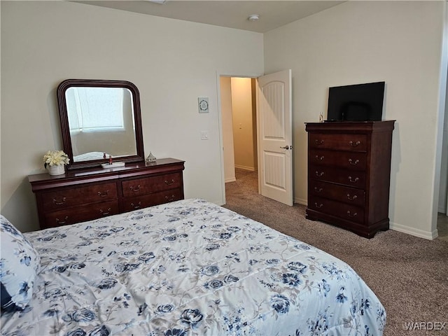 bedroom featuring baseboards and dark colored carpet