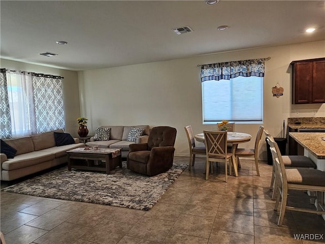 tiled living area with recessed lighting and visible vents