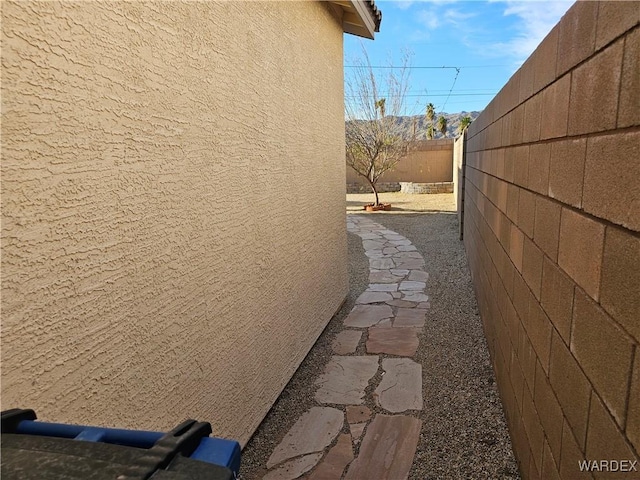 view of property exterior featuring a fenced backyard and stucco siding