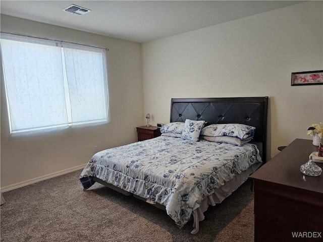 bedroom featuring dark colored carpet, visible vents, and baseboards